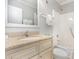 Well-lit bathroom features a granite countertop, a shower-tub combo, and ample storage space beneath the sink at 1011 S Ocean Blvd., Surfside Beach, SC 29575