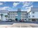 Beautiful exterior of a multi-story condo building with ample parking, blue facade, and balconies at 1011 S Ocean Blvd., Surfside Beach, SC 29575