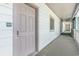 Hallway view featuring unit 102 entrance door with electronic lock and outdoor carpet at 1011 S Ocean Blvd., Surfside Beach, SC 29575