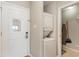 Convenient laundry area with stacked washer and dryer and an ironing board at 1011 S Ocean Blvd., Surfside Beach, SC 29575