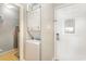 Convenient laundry area with stacked washer/dryer unit, shelving for storage, and easy access to outside at 1011 S Ocean Blvd., Surfside Beach, SC 29575