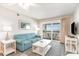 Inviting living room with comfortable seating, TV, and access to a private balcony at 1011 S Ocean Blvd., Surfside Beach, SC 29575