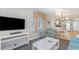 Open-concept living area with a comfortable seating and large TV at 1011 S Ocean Blvd., Surfside Beach, SC 29575