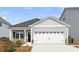 Charming single-story home featuring a two-car garage, craftsman details and tidy landscaping at 1013 Hainer Place Dr, Conway, SC 29526