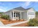 Charming single story home with covered front porch and manicured landscaping at 1013 Hainer Place Dr, Conway, SC 29526