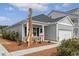 Charming single story home with covered front porch, manicured landscaping, and spacious garage at 1013 Hainer Place Dr, Conway, SC 29526