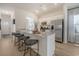 Well-lit kitchen with granite counters, stainless appliances, a breakfast bar, and wood flooring at 1013 Hainer Place Dr, Conway, SC 29526