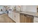 Modern kitchen featuring granite countertops, stainless appliances, and a partial view of the living room at 1013 Hainer Place Dr, Conway, SC 29526
