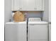 Well-lit laundry room featuring a white washer and dryer set and white cabinetry for ample storage space at 1013 Hainer Place Dr, Conway, SC 29526