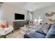 Stylish living room with modern decor, a comfortable blue sofa, and sliding glass doors to the backyard at 1013 Hainer Place Dr, Conway, SC 29526