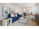 Spacious living area with hardwood floors, stylish seating, and an open view to the dining area and kitchen at 1013 Hainer Place Dr, Conway, SC 29526
