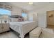A bright main bedroom offers a bed and a bench with views of the bathroom and closet at 1013 Hainer Place Dr, Conway, SC 29526