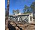 New home features horizontal light beige siding and an attached garage providing modern comfort in a wooded lot at 1028 Colette Ct, Conway, SC 29526