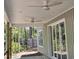 Covered patio with ceiling fans and sliding glass doors offer outdoor living space in a private backyard at 1028 Colette Ct, Conway, SC 29526