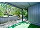 Covered back patio with green turf and views of lush landscaping at 10301 N Kings Hwy. # 21-5, Myrtle Beach, SC 29572