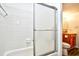 Clean bathroom featuring white tiled walls, a shower with glass door, and wood-finished vanity at 10301 N Kings Hwy. # 21-5, Myrtle Beach, SC 29572