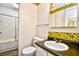 The bathroom showcases a vanity with a large mirror with framed floral wallpaper and bathtub with shower at 10301 N Kings Hwy. # 21-5, Myrtle Beach, SC 29572