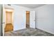 Bedroom with an adjoining closet and adjacent room through a doorway with neutral paint at 10301 N Kings Hwy. # 21-5, Myrtle Beach, SC 29572