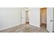 A carpeted bedroom reveals a doorway and closet with shelving, offering lots of storage solutions at 10301 N Kings Hwy. # 21-5, Myrtle Beach, SC 29572