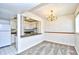 View of dining area with chandelier and pass-through to the adjacent kitchen at 10301 N Kings Hwy. # 21-5, Myrtle Beach, SC 29572