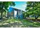 Charming view of the home's exterior and backyard, surrounded by lush green trees and vegetation at 10301 N Kings Hwy. # 21-5, Myrtle Beach, SC 29572