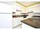 Bright kitchen featuring white cabinets, tile flooring, and a fun lemon-themed wallpaper border at 10301 N Kings Hwy. # 21-5, Myrtle Beach, SC 29572
