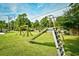 Community playground featuring a metal slide, swing set, and green grassy area at 10301 N Kings Hwy. # 21-5, Myrtle Beach, SC 29572