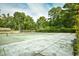 Outdoor tennis courts surrounded by mature trees offer a recreational space for residents at 10301 N Kings Hwy. # 21-5, Myrtle Beach, SC 29572