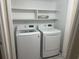 Bright laundry room with modern LG washer and dryer and storage shelves above at 10301 N Kings Hwy. # 22-11, , SC 29572