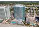Stunning aerial view of a condo complex with pools and pristine beach access, blending luxury and leisure at 107 S Ocean Blvd. # 1402, Myrtle Beach, SC 29577