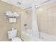 Full bathroom featuring a combined tub and shower, a toilet, and fresh white towels at 107 S Ocean Blvd. # 1402, Myrtle Beach, SC 29577