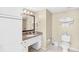 Well-lit bathroom with granite countertop vanity, mirror, and linen storage, adjacent to a toilet at 107 S Ocean Blvd. # 1402, Myrtle Beach, SC 29577