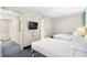 Bright room features two beds, TV, ensuite bath, and easy access to ocean view balcony at 107 S Ocean Blvd. # 1402, Myrtle Beach, SC 29577