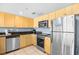Cozy kitchen features stainless appliances, sleek cabinets and solid surface countertops at 107 S Ocean Blvd. # 1402, Myrtle Beach, SC 29577