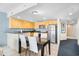 A well-lit kitchen with stainless steel appliances and sleek cabinets adjacent to a dining area at 107 S Ocean Blvd. # 1402, Myrtle Beach, SC 29577