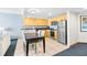 A well-lit kitchen with stainless steel appliances and sleek cabinets adjacent to a dining area at 107 S Ocean Blvd. # 1402, Myrtle Beach, SC 29577