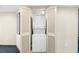 Convenient laundry closet featuring stacked washer and dryer unit with folding doors at 107 S Ocean Blvd. # 1402, Myrtle Beach, SC 29577