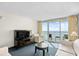 Bright living room with large windows overlooking ocean views and comfortable seating at 107 S Ocean Blvd. # 1402, Myrtle Beach, SC 29577