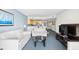 Open living space with stylish sofas, TV, leading into a well-equipped kitchen area at 107 S Ocean Blvd. # 1402, Myrtle Beach, SC 29577