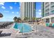 Inviting outdoor swimming pool surrounded by lounge chairs and modern resort buildings at 107 S Ocean Blvd. # 1402, Myrtle Beach, SC 29577