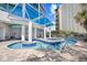 Serpentine in-ground pool with tiled details and covered lounge area, offering a resort-style experience at 107 S Ocean Blvd. # 1402, Myrtle Beach, SC 29577