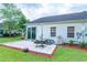 Backyard patio view with exterior of the home and well maintained lawn at 111 Rose Water Loop # 111, Myrtle Beach, SC 29588