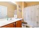 Bathroom featuring a sink, toilet, and shower with a palm tree-themed shower curtain at 111 Rose Water Loop # 111, Myrtle Beach, SC 29588