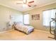 Cozy bedroom with natural light, a ceiling fan, carpeted flooring, and neutral-colored walls at 111 Rose Water Loop # 111, Myrtle Beach, SC 29588