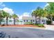 Charming white clubhouse with lush landscaping and palm trees, a community focal point at 111 Rose Water Loop # 111, Myrtle Beach, SC 29588
