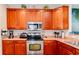 Kitchen featuring wooden cabinets, stainless steel appliances, and tile flooring at 111 Rose Water Loop # 111, Myrtle Beach, SC 29588