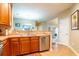 Well-lit kitchen featuring stainless steel appliances, wooden cabinetry, and a double-basin sink at 111 Rose Water Loop # 111, Myrtle Beach, SC 29588