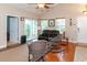 Open living room with hardwood floors, vaulted ceiling, area rug, and sliding glass doors at 111 Rose Water Loop # 111, Myrtle Beach, SC 29588
