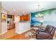 Living room with a leather recliner, tile flooring and vibrant ocean mural at 111 Rose Water Loop # 111, Myrtle Beach, SC 29588