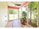 Bright sunroom featuring tile flooring, a ceiling fan, and large windows showcasing the landscape at 111 Rose Water Loop # 111, Myrtle Beach, SC 29588